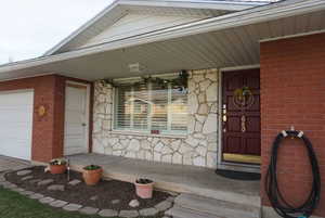 Front porch with entry to home and garage