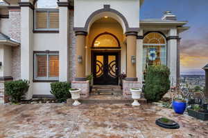 Doorway to property with a chimney and stucco siding