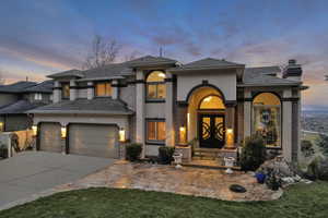 View of front of property with driveway, french doors, a chimney, and stucco siding