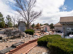 View of yard with a storage shed and an outdoor structure