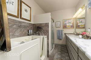 Bathroom with a bath, vanity, wood finished floors, a stall shower, and baseboards