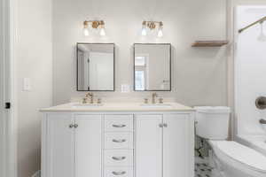 Full bath featuring double vanity
