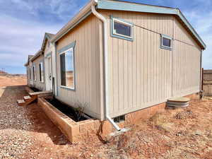 View of property exterior featuring fence