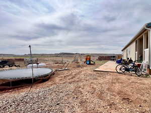 View of yard with a patio area, fence, and a playground