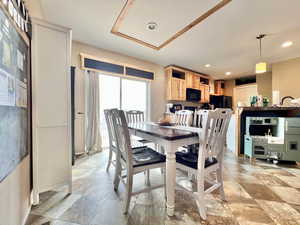 Dining space with stone finish flooring and recessed lighting