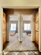 Hall featuring carpet flooring