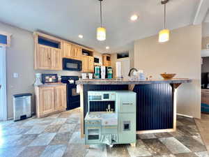 Kitchen with open shelves, light brown cabinets, recessed lighting, black appliances, and stone finish flooring