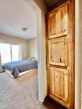 Bedroom featuring dark carpet