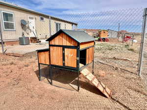 View of storm shelter with exterior structure and an outbuilding