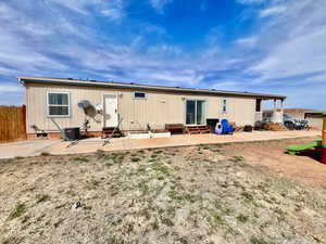 Rear view of house with cooling unit, crawl space, entry steps, a patio, and fence