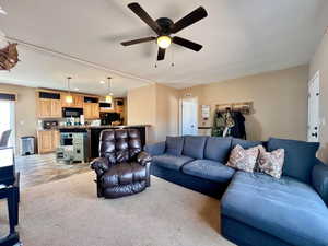Living area featuring light colored carpet, a ceiling fan, visible vents, and recessed lighting