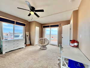 Interior space featuring a ceiling fan and carpet