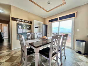 Dining area featuring baseboards and stone finish floor