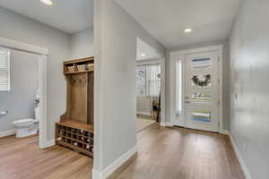 Mudroom featuring baseboards, recessed lighting, and light wood-style floors