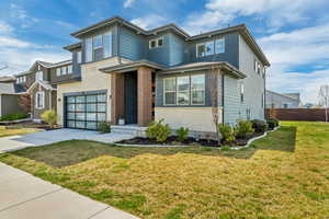 View of front of property with a garage, a front yard, driveway, and fence