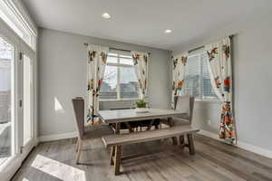 Dining space featuring wood finished floors, baseboards, and recessed lighting