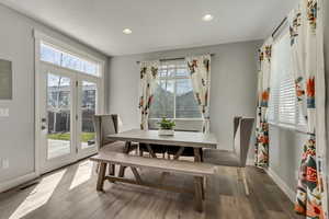 Dining room featuring visible vents, baseboards, recessed lighting, and wood finished floors