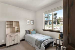Bedroom featuring baseboards and light colored carpet