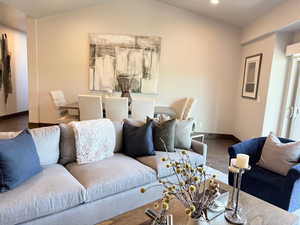 Living area featuring wood finished floors, recessed lighting, and vaulted ceiling