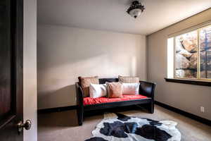Living area with carpet flooring and baseboards