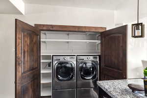 Washroom featuring washer and dryer and laundry area