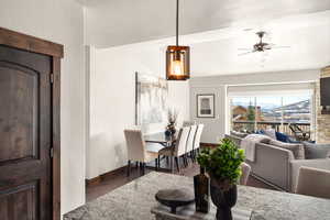 Dining room with baseboards, a ceiling fan, and wood finished floors