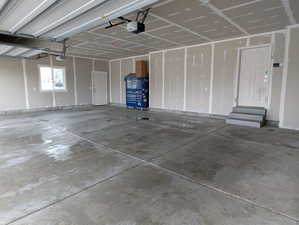 3 Car Garage featuring a garage door openers