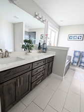 Full bath featuring a sink, visible vents, a bath, and double vanity
