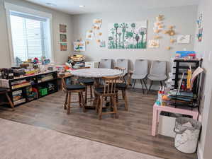 Dining area with recessed lighting, visible vents, and wood finished floors. Plumbed and wired for basement kitchenette.