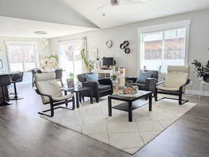 Living area with a ceiling fan, LVP floors and lofted ceiling