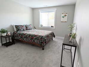 Carpeted bedroom featuring visible vents and baseboards