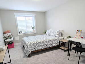 Bedroom featuring carpet flooring, visible vents, and baseboards