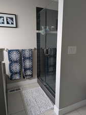 Bathroom featuring visible vents, baseboards, a stall shower, and tile patterned flooring