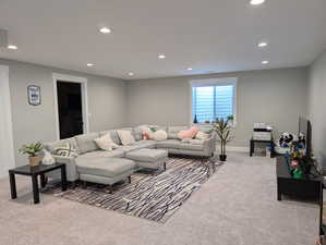 Carpeted living area with recessed lighting