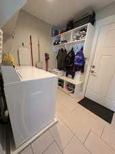Laundry and mud  room featuring independent washer and dryer.