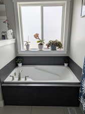 Full bathroom featuring visible vents and a garden tub