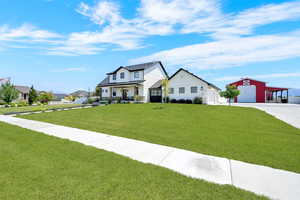 Modern Farmhouse with barndoor Breezeway enclosure between the residence and 3 car carriage garage and view of additional barn with lean-to.