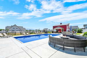 View of 20x40 vinyl sports liner salt water pool, a gazebo, a patio, and a fenced backyard
