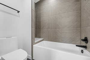 Bathroom with toilet and tub / shower combination