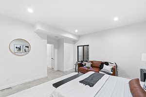 Bedroom featuring concrete flooring, visible vents, baseboards, and recessed lighting