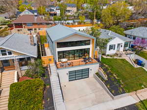 View of front of home featuring fence, a front lawn, an attached garage, concrete driveway, and a residential view