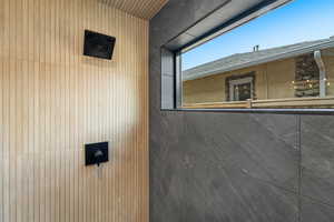 Room details featuring a tile shower