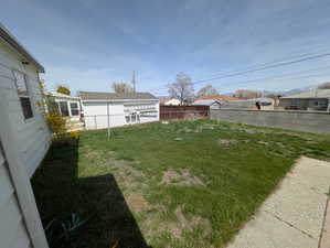 View of yard featuring fence
