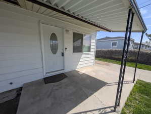 Doorway to property with a patio area