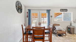 Dining room featuring french doors, baseboards, and washer / dryer