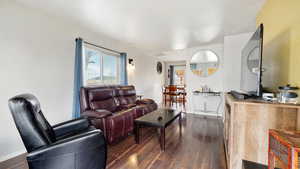 Living area with baseboards and wood finished floors