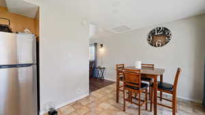 Dining room featuring baseboards and attic access