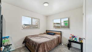 Carpeted bedroom featuring baseboards