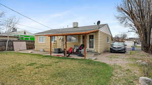 Back of property with central AC, fence, a yard, and a patio area