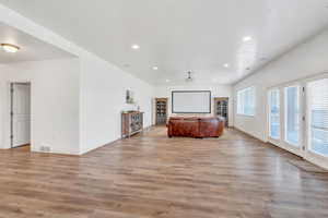 Unfurnished living room featuring visible vents, baseboards, recessed lighting, and light wood-style floors